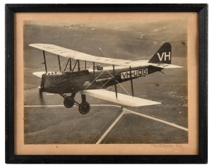 SIR CHARLES KINGSFORD SMITH original black and white albumen photograph of the famed aviator in flight piloting the SOUTHERN CROSS MINOR, photograph signed in pencil lower right "J. T. Harrison, Melb.", sheet size 23.5 x 31cm, 30.5 x 38cm overall.