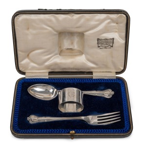 WILLIAM DRUMMOND & Co. of MELBOURNE antique English sterling silver napkin ring, fork and spoon set, housed in original plush fitted retailer's box, early 20th century, the box 20cm wide, 98 grams silver weight.