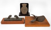 MARITIME GROUP comprising of bronze plaque mounted on timber base, bronze cleat and a propeller mounted on board, 19th/20th century, (3 items), the largest 40cm wide.