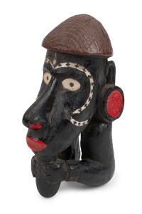 Nguzu Nguzu canoe prow, carved wood, inlaid with shell and decorated with later painted enhancement, Solomon Islands, 19th/20th century, 14.5cm high.