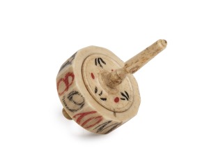 An antique carved whalebone gaming top, 18th/19th century, 6cm high.