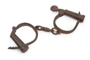 Antique adjustable handcuffs with original screw key and broad arrow mark, 19th century, 25cm wide.