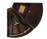 An antique English ebony and ivory nautical ctant in later timber case, 19th century, ​​​​​​​the case 45cm high overall. - 2