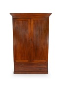 A Colonial Australian cedar two door wardrobe with two long drawers to the base, interior fitted with hanging space on one side and shelving on the other, New South Wales origin, circa 1860, 207cm high, 136cm wide, 56cm deep.