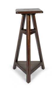 An antique beech revolving pedestal with tri-form base and peg joint construction, 19th/20th century, 112cm high, 41cm wide, 41cm deep.