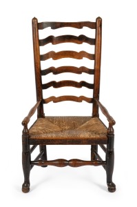 An antique English oak and elm ladderback nursing chair with rush seat and pad feet, 18th/19th century, 97cm high, 52cm across the arms.