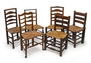 Six assorted antique English oak and elm ladderback chairs with rush seats, 19th century.