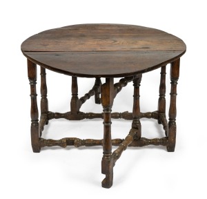 An antique English oak drop-side table with stretcher base, early to mid 18th century, 76cm high, 118cm wide, 61cm (extends to 151cm) deep.