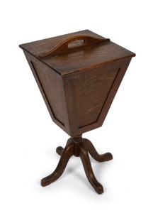 A vintage English oak sewing tidy with lift-top compartments, early 20th century, 57cm high, 30cm wide, 31cm deep.