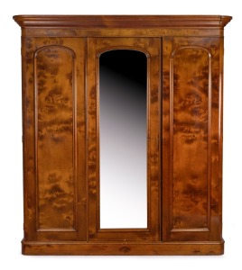 An antique Australian huon pine three door wardrobe with figured birdseye panels and mirrored centre, Melbourne origin, circa 1875, 210cm high, 190cm wide, 58cm deep.