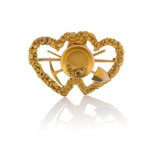 An antique 18ct gold sweetheart gold miner's brooch with crossed pick and shovel, gold pan and intertwined double love heart fashioned from gold nugget specimens, stamped "NATIVE GOLD", 3.7cm wide, 6.3 grams.