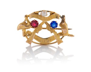 ALFRED JACKSON of Fremantle WW1 period patriotic 9ct gold brooch with crossed rifles, emu and kangaroo, emblazoned "AUSTRALIA WILL BE THERE", set with a seed pearl plus red and blue stones, stamped "9.C." with pictorial mark, 3.6cm wide, 3.6 grams.