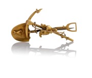 An antique 15ct gold miner's brooch with crossed pick and shovel plus gold nugget specimens, ​​​​​​​4.8cm wide, 6.2 grams.