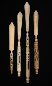 Four antique carved whalebone letter openers, one with Stanhope image intact (the others missing), 19th century, the largest 23cm long.