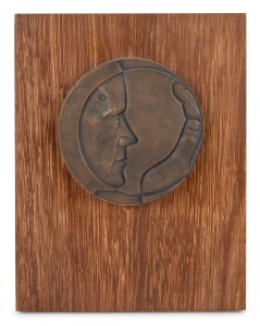 MICHAEL MESZAROS (1945 - ) circular bronze plaque mounted on blackbean board, signed "Michael Meszaros, 1975", 25 x 19cm overall.