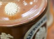 LIPSCOMBE & Co. of Manchester, antique English stoneware water filter with sprig moulded decoration and English coat of arms, 19th century, 45cm high. - 2