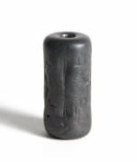ANTIQUITIES: Cypriot haematite cylinder seal engraved with five figures, including a winged entity and a soldier wearing a crested helmet, engaged in ritual animal sacrifice. 1400-1200 BC. Length 2.8cm (Copy of attribution by British Museum available). - 2