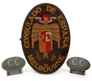 Ovular timber plaque from the Melbourne consulate of Francoist Spain, c. 1970, with text "Consulado De Espa&ntilde;a En Melbourne", height 48cm, together with two Melbourne Consular Corps plaques, both approx. 12 x 16cm. (3 items)