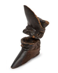 An antique carved wooden novelty nutcracker, 18th/19th century, as is condition with numerous losses, ​​​​​​​15cm high.