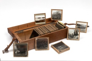 [NEW GUINEA] Collection of 52 photographic glass Magic Lantern slides (mostly indigenous subjects and missionaries, apparently taken in the Trobriand Islands), T. W. Cameron maker, housed in original wooden box with five additional religious slides, early
