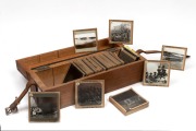 [NEW GUINEA] Collection of 52 photographic glass Magic Lantern slides (mostly indigenous subjects and missionaries, apparently taken in the Trobriand Islands), T. W. Cameron maker, housed in original wooden box with five additional religious slides, early