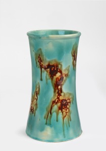 McHUGH pottery vase with unusual green and mottled brown glaze, incised "H. McHugh, Tasmania", 22.5cm high.