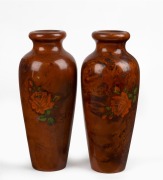 A pair of vintage Tasmanian birdseye huon pine mantle vases, each adorned with applied rose decoration, circa 1920, ​​​​​​​22cm high.