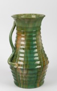 REMUED ribbed green glazed pottery vase with applied branch handle (rare shape), incised signature "Remued, 463", 38cm high.