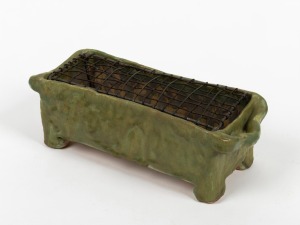 HAROLD HUGHAN unusual green glazed pottery flower trough with wire insert aid, incised "Hand Built, Nov. 1944, Hughan", 10cm high, 30cm wide.