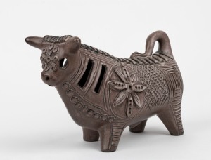 McLAREN brown glazed pottery bull statue, incised "McLaren", 17.5cm high, 30cm long.