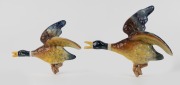 M.C.P. graduated pair of pottery flying ducks, impressed circular factory mark verso, 27.5cm and 22.5cm long.