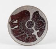 JANET MANSFIELD "International Year Of The Woman" pottery plate. This piece is of a series commissioned by the Whitlam Government in 1975, a similar example is held in the Powerhouse Museum, impressed seal mark to base, 24cm diameter.
