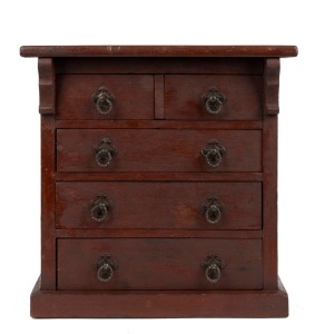 A stained pine five drawer miniature chest with carved corbels and metal handles, 20th century, 37cm high, 38cm wide, 20cm deep.