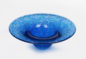 An Australian speckled blue art glass vase, engraved signature to base (illegible), ​​​​​​​7cm high, 20cm diameter.