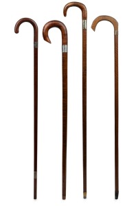 Four assorted Australian timber walking sticks with silver collars, 19th/20th century, the largest 93cm high.