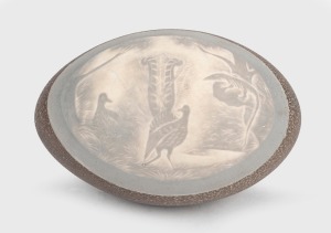 An antique Australian emu egg ornament carved with lyrebird decoration in landscape, 19th/20th century, 14cm long.