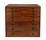 A bank of eight printer's drawers, Australian kauri pine with ebonised knobs, five drawers fitted with numerous compartments, 19th/20th century, 53cm high, 59cm wide, 46cm deep.