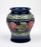 MOORCROFT "Banded Pomegranate" miniature pottery vase on blue ground, impressed "Moorcroft, Made In England", 8cm high. - 2