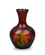 MOORCROFT flambe "Leaves and Berries" miniature pottery stem vase, impressed signature mark to base "Moorcroft, Potter To H.M. The Queen, Made In England", 9cm high.