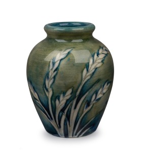MOORCROFT "Waving Corn" miniature pottery vase on celadon and blue ground, impressed signature mark to base "Moorcroft Potter To H.M. The Queen, Made In England", 8.5cm high.