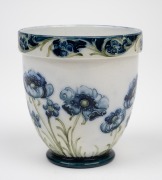 MOORCROFT "Blue Poppy" pattern pottery vase on cream ground, stamped "MACINTYRE, Burslem, England" with "W.M.", ​​​​​​​9cm high. - 2