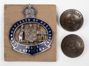 "COMMONWEALTH OF AUSTRALIA PEACE OFFICER" hat badge by Stokes; together with 2 jacket buttons, also by Stokes. (3 items).