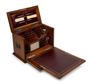 A fine quality antique English oak travelling compendium with attractively fitted interior and fold out burgundy writing surface, adorned with silver monogram plaque and escutcheon, 19th century, ​​​​​​​20cm high, 29cm wide, 16cm deep.