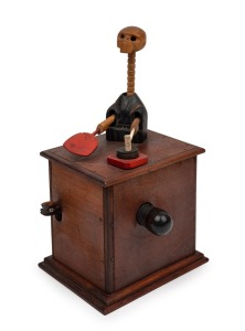 An antique Japanese Kobe carved automata clockwork toy, early 20th century, 18cm high.