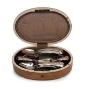 An antique Dutch silver fourteen piece spoon set housed in original oval maple box lined in velvet and silk with ivory edging and mirrored base, 19th/20th century, the box 18.5cm wide, 170 grams silver weight.
