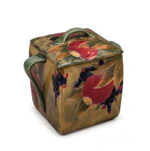 MOORCROFT "Pomegranate" pottery biscuit barrel on celadon green ground, underglazed green signature mark to base, and impressed "Moorcroft Burslem", 16cm high.