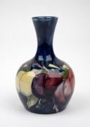 MOORCROFT "Wisteria" miniature pottery stem vase on blue ground, impressed "Moorcroft, Made In England", 9.5cm high. - 2
