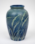 MOORCROFT "Wind Swept" salt glazed pottery vase on blue ground, impressed signature mark to base "Moorcroft, Potter To H.M. The Queen, Made In England", 24.5cm high. - 2