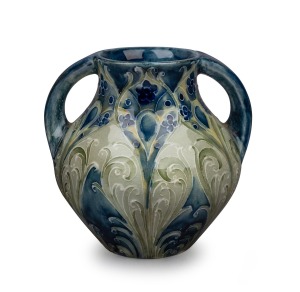 MOORCROFT "Florian Peacock Feather" two handled miniature pottery vase on blue ground, signed "Moorcroft, MADE FOR LIBERTY & CO.", 8cm high.