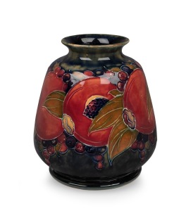 MOORCROFT "Pomegranate" pattern pottery vase on unusual mottled celadon and blue ground, impressed "Moorcroft, Burslem, England" and with green signature mark, 14.5cm high.